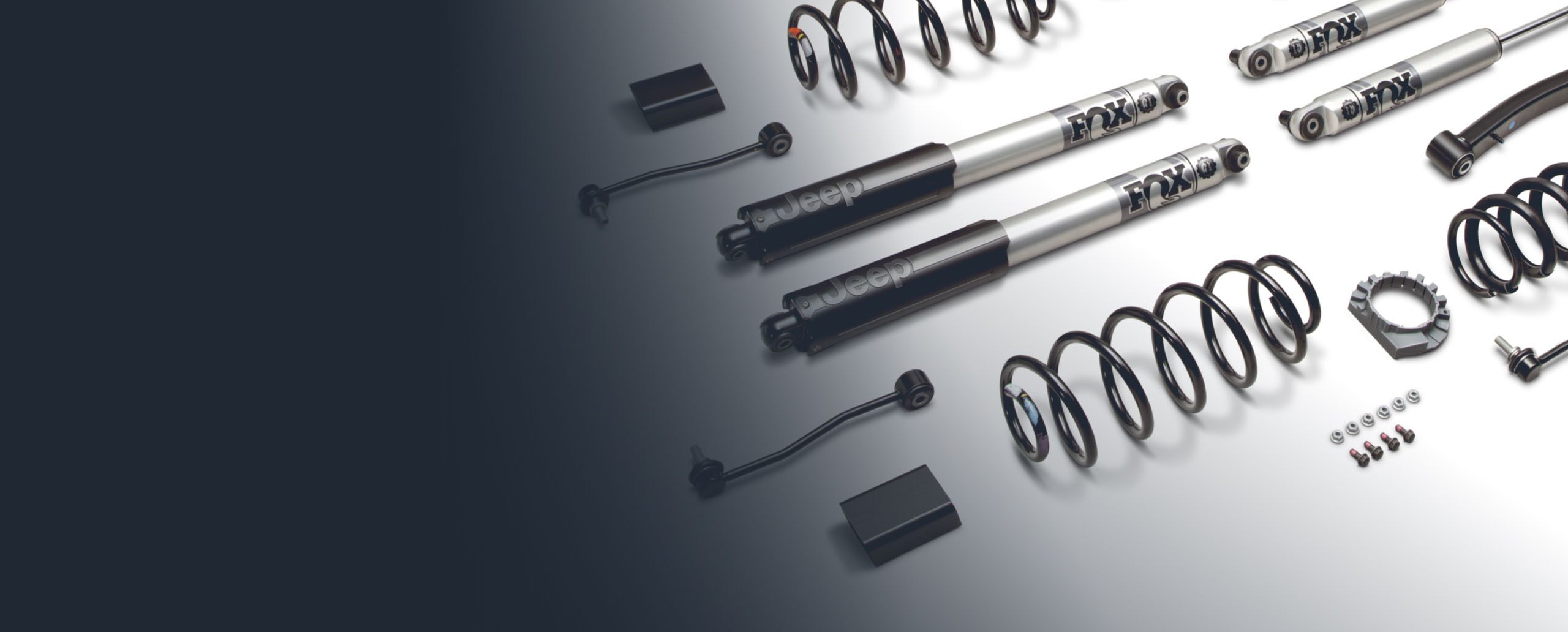 A close-up of parts included in the Jeep Performance Parts 2-inch lift kit, including Fox-branded shocks.
